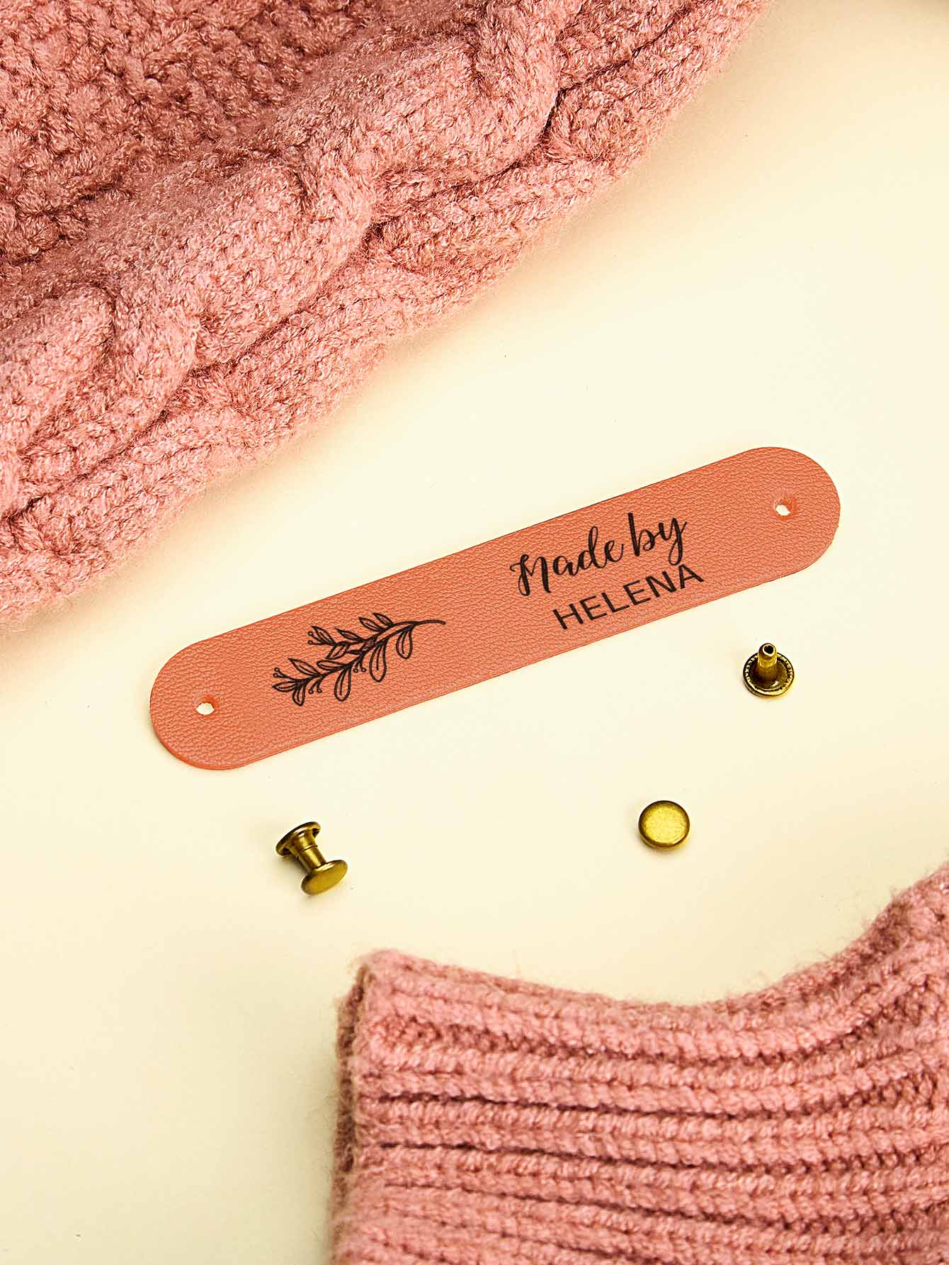 Personalised PVC tag shown on a handmade scarf for a professional finishing touch