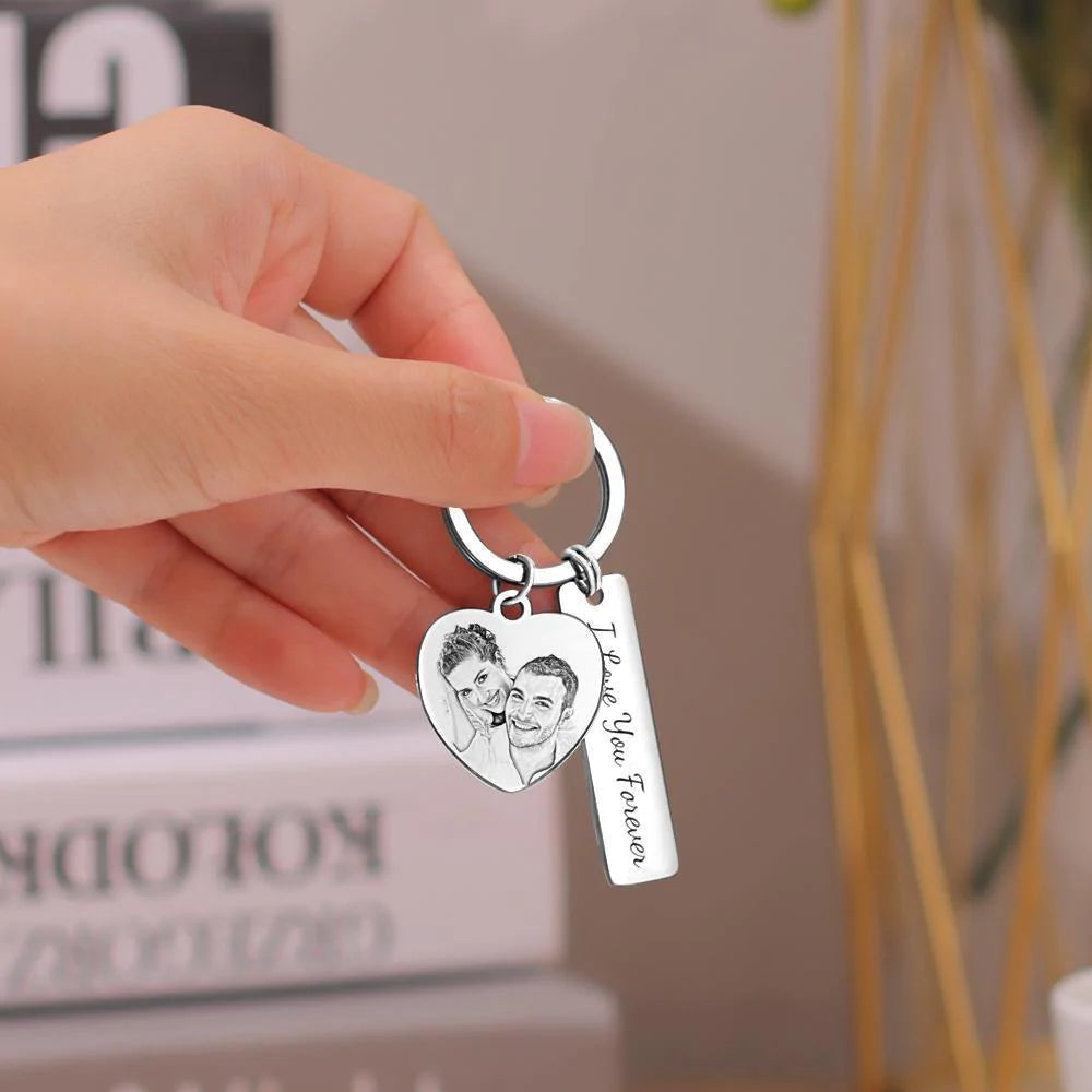 Close-up of personalised engraved stainless steel keyring showing detailed photo engraving and custom text on polished pendant