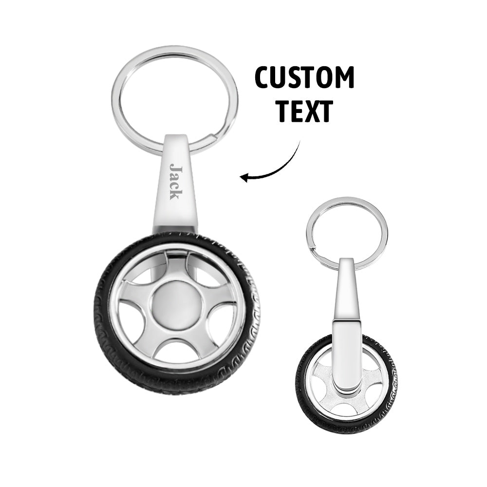 Personalised tyre keyring crafted from metal and rubber, engraved name on alloy-style rim and smooth spinning mechanism for car enthusiasts