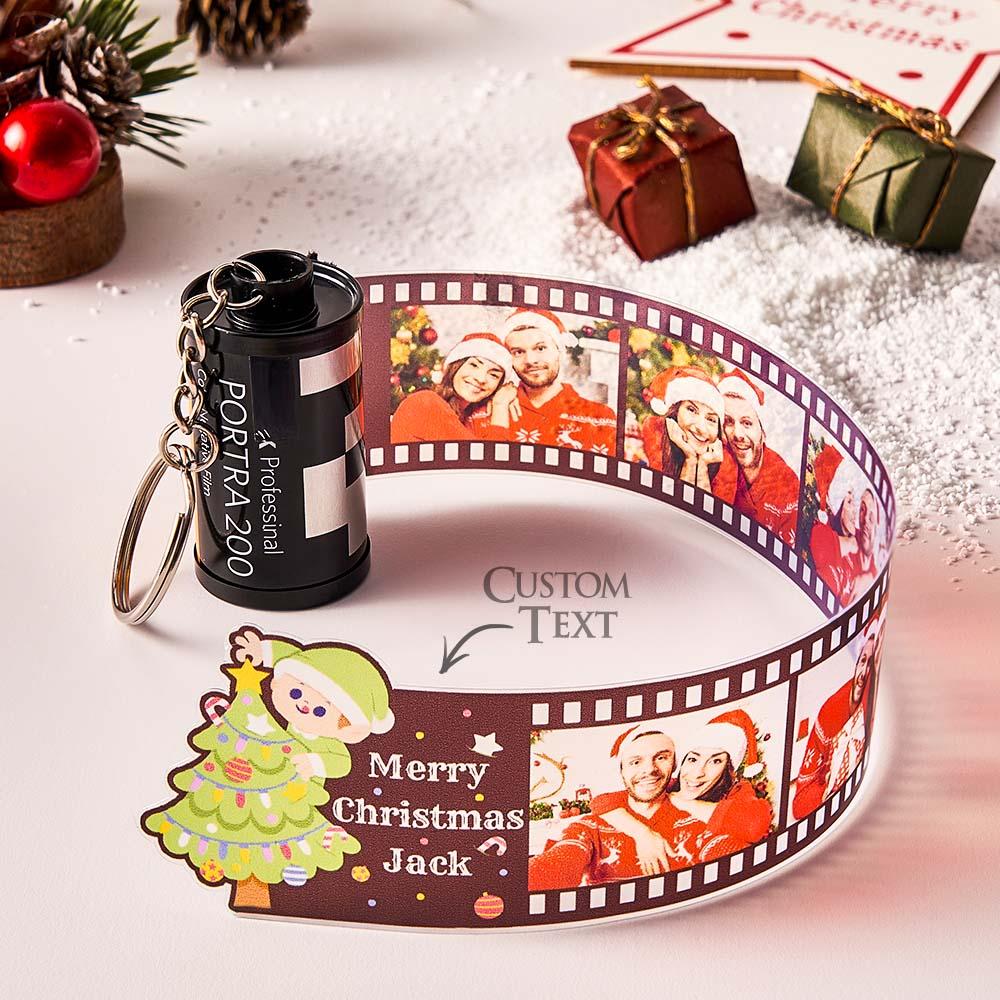 Personalised camera film roll keychain close-up showing film-strip design with inserted photos and custom text — custom photo keyring gift