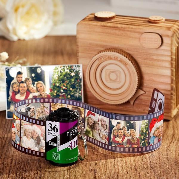 Custom film roll keyring laid flat displaying up to 10 printed photos on a recreated camera film strip - eco-friendly personalised keepsake