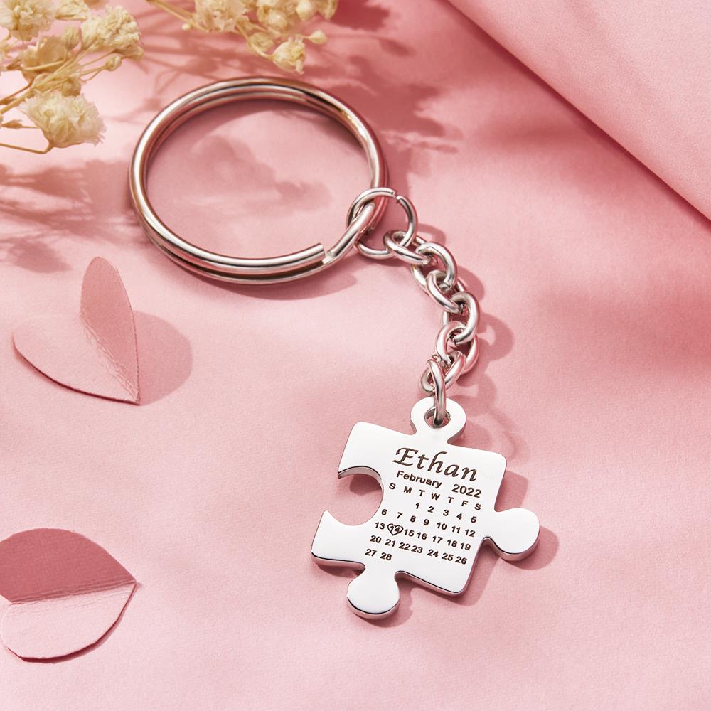 Two interlocking stainless steel puzzle keyrings forming a keepsake with engraved calendar and initials ideal as a custom anniversary gift