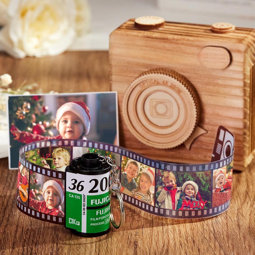 Angled view of the personalised film-roll keyring with green shell packaging and white presentation box.