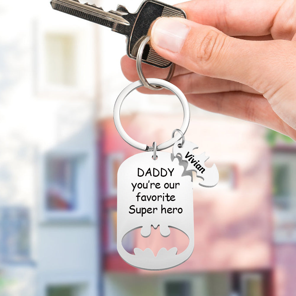 Close-up of personalised stainless steel Superhero Daddy keyring showing engraved children's names and durable finish