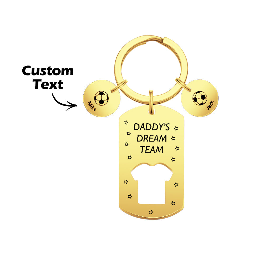 Personalised keyring assembly with engraved football charm and name bars displayed on a wooden surface – thoughtful gift for father