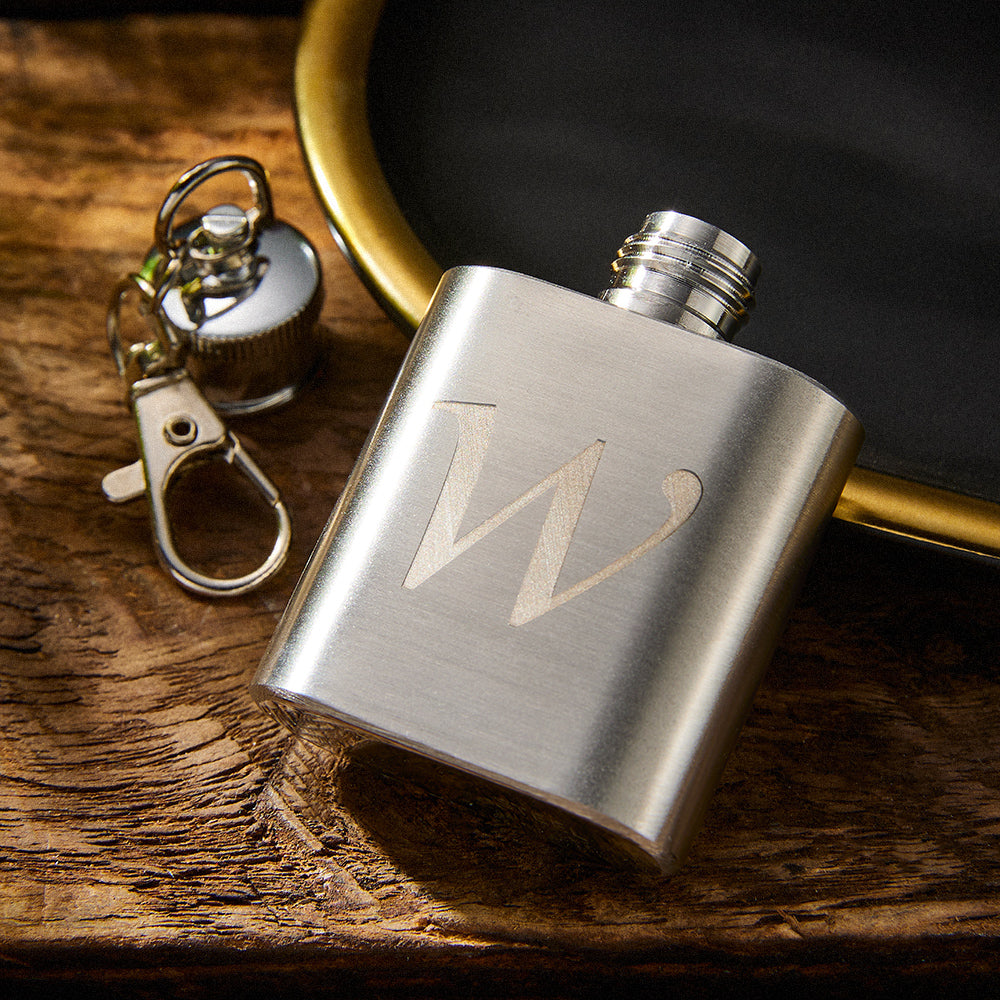 Compact personalised stainless steel rectangle hip flask keyring clipped to keys, showing custom engraving and sleek polished finish — travel‑friendly keepsake gift
