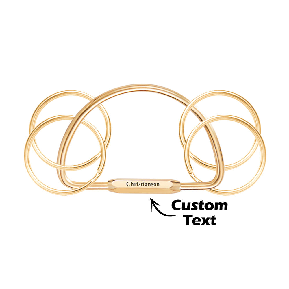Selection of multi-layer brass keyrings in gold, rose gold, silver and black finishes — custom name keychains available in multiple plated styles, popular in the UK and Australia.