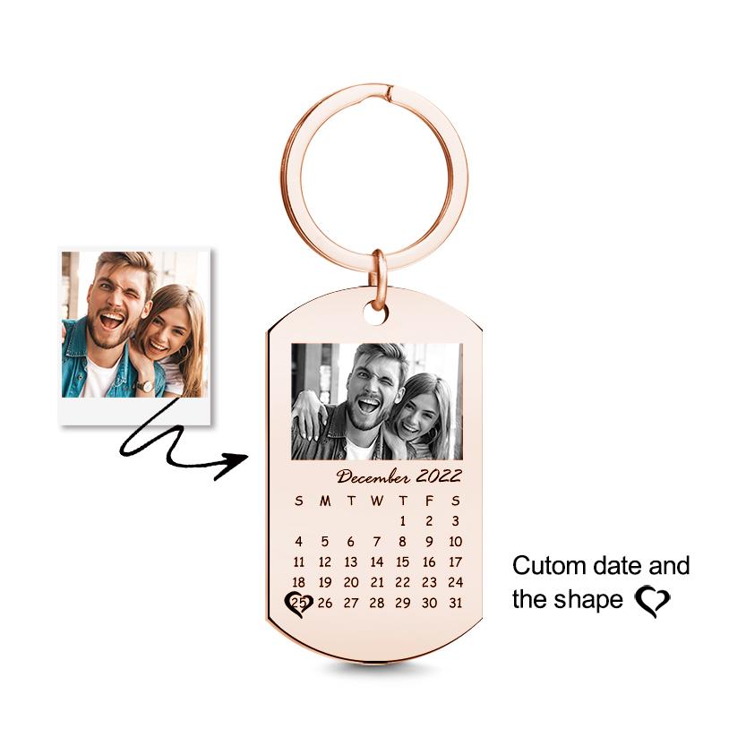 Angled view of a personalised black photo calendar keyring highlighting the durable black finish and neat engraved-style calendar — great personalised gift for men.
