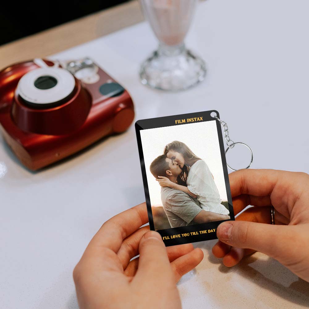 Close-up of fine engraving detail on the Polaroid photo pass, handcrafted personalised keyring keepsake
