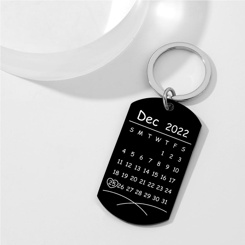Close-up of personalised stainless steel keyring with printed photo and mini calendar engraving, durable finish and compact everyday carry