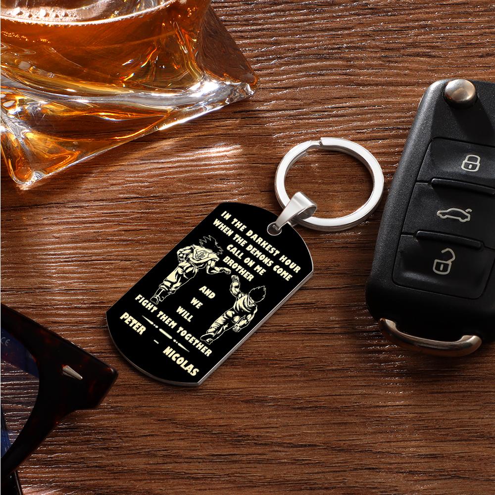 Keyring shown paired with personal items to illustrate scale — compact personalised stainless steel engraved tag for pockets or bags.