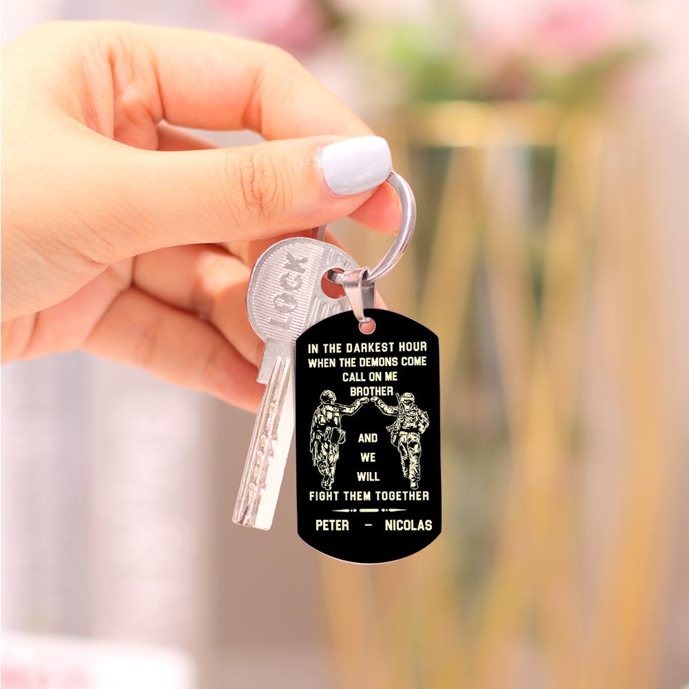 Top-down view of the engraved tag keyring showing the split-ring and solid metal construction for everyday wear.