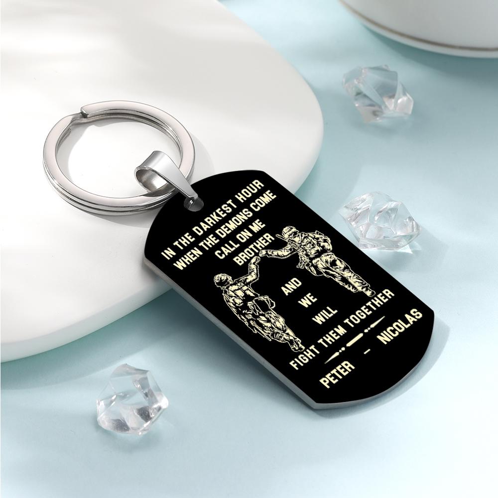 Close crop highlighting the brushed stainless finish and deep engraving of the Call On Me Brother keepsake keyring.