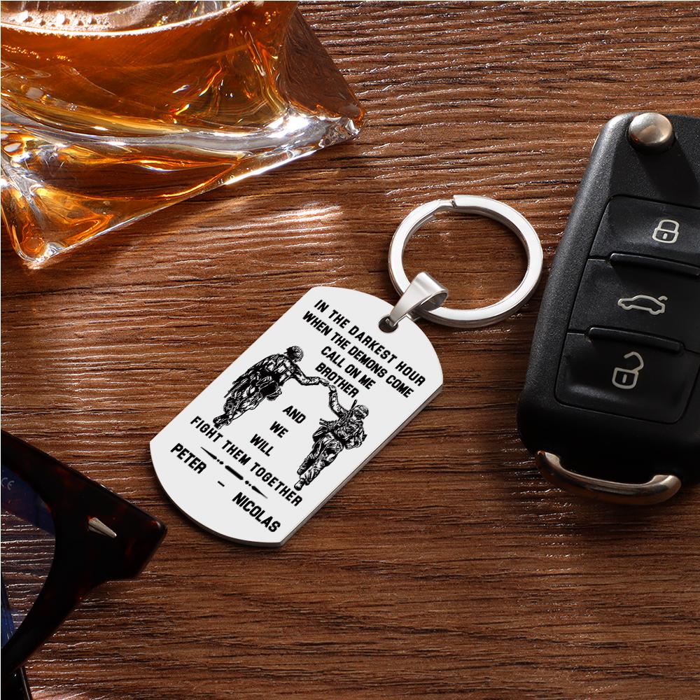 Close crop of personalised engraving options with example text 'In the darkest hour, call on me' on a stainless tag.