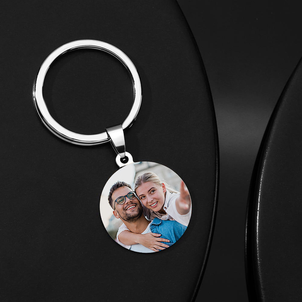 Close-up of custom name stainless steel keychain showing engraved message and clear photo reproduction on a personalised 'Drive Safe' photo keyring
