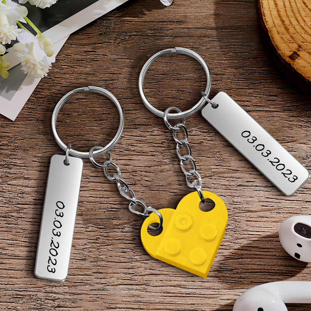 Lifestyle image of personalised heart brick keychains attached to a bag, demonstrating everyday use as a romantic keepsake