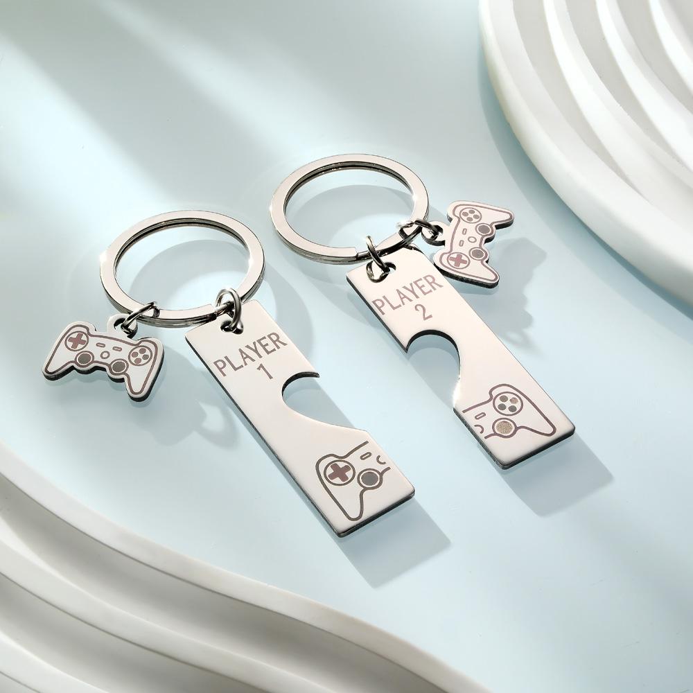 Close-up of personalised engraving on a retro game console keyring showing names and clear contrast — engraved keyring detail