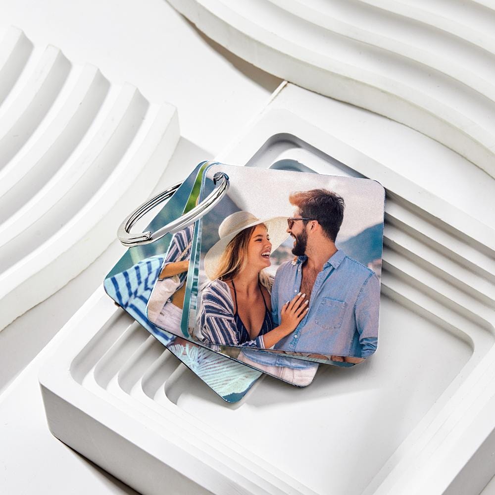 Hand holding personalised photo flip book keyring with clear acrylic panels and metal ring — thoughtful personalised gift for her