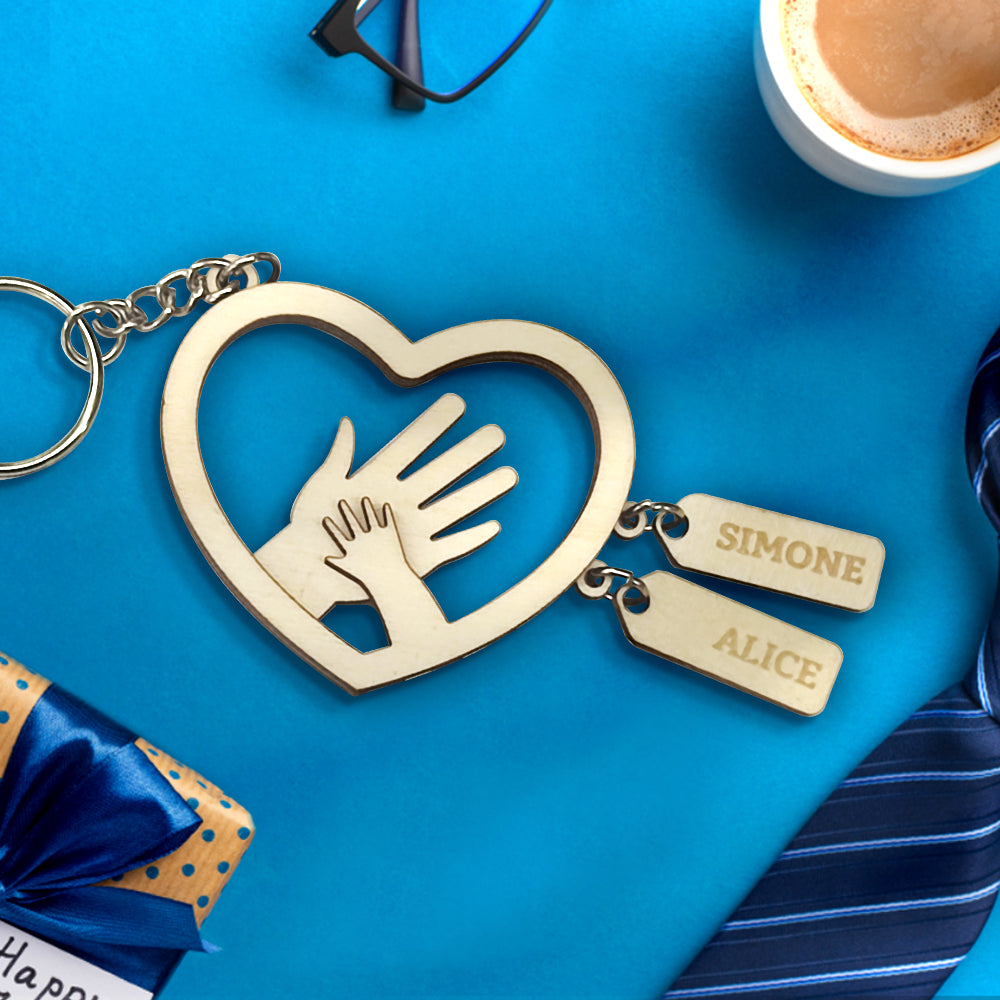 Personalised hands name tag styled on a leather bag to show scale and wearability – custom engraved names make a heartfelt gift for grandad or father
