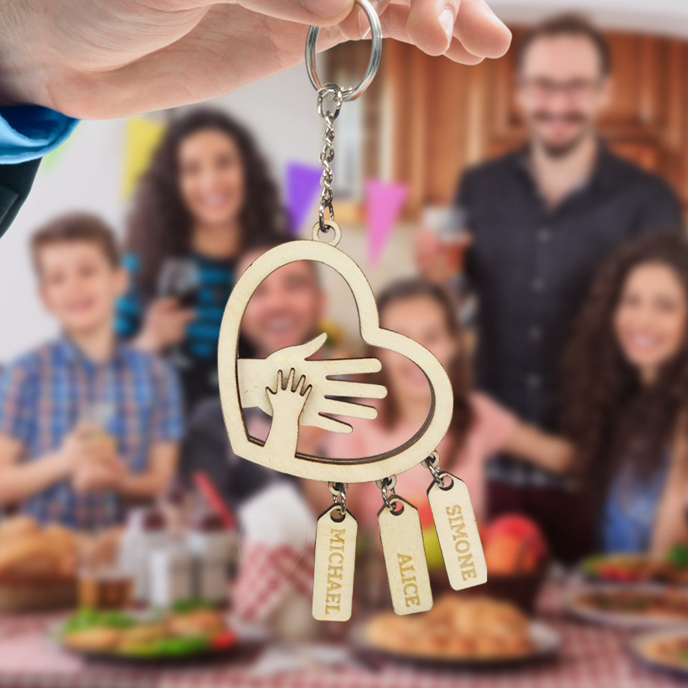 Lifestyle image of a father holding keys with a personalised hands name tag attached, engraved with children's names – sentimental custom gift for dad