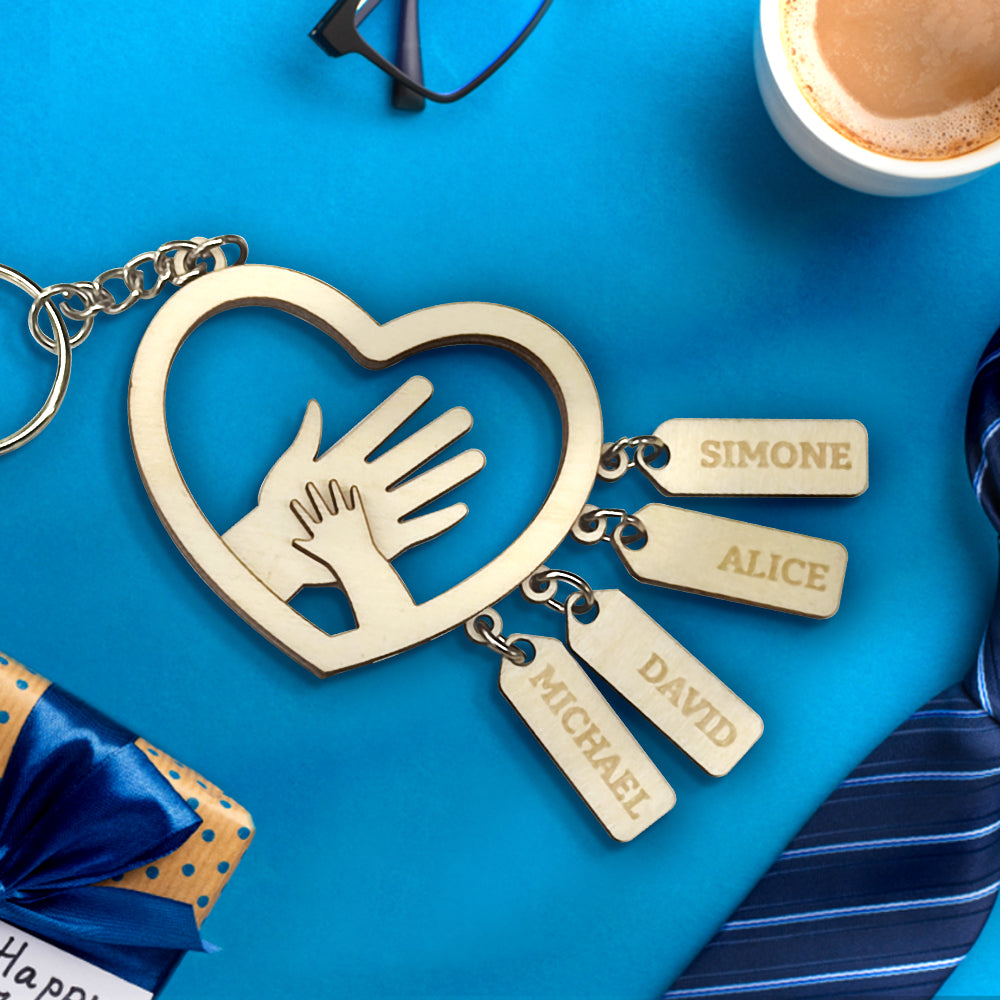 Lifestyle image of a father holding keys with a personalised hands name tag attached, engraved with children's names – sentimental custom gift for dad