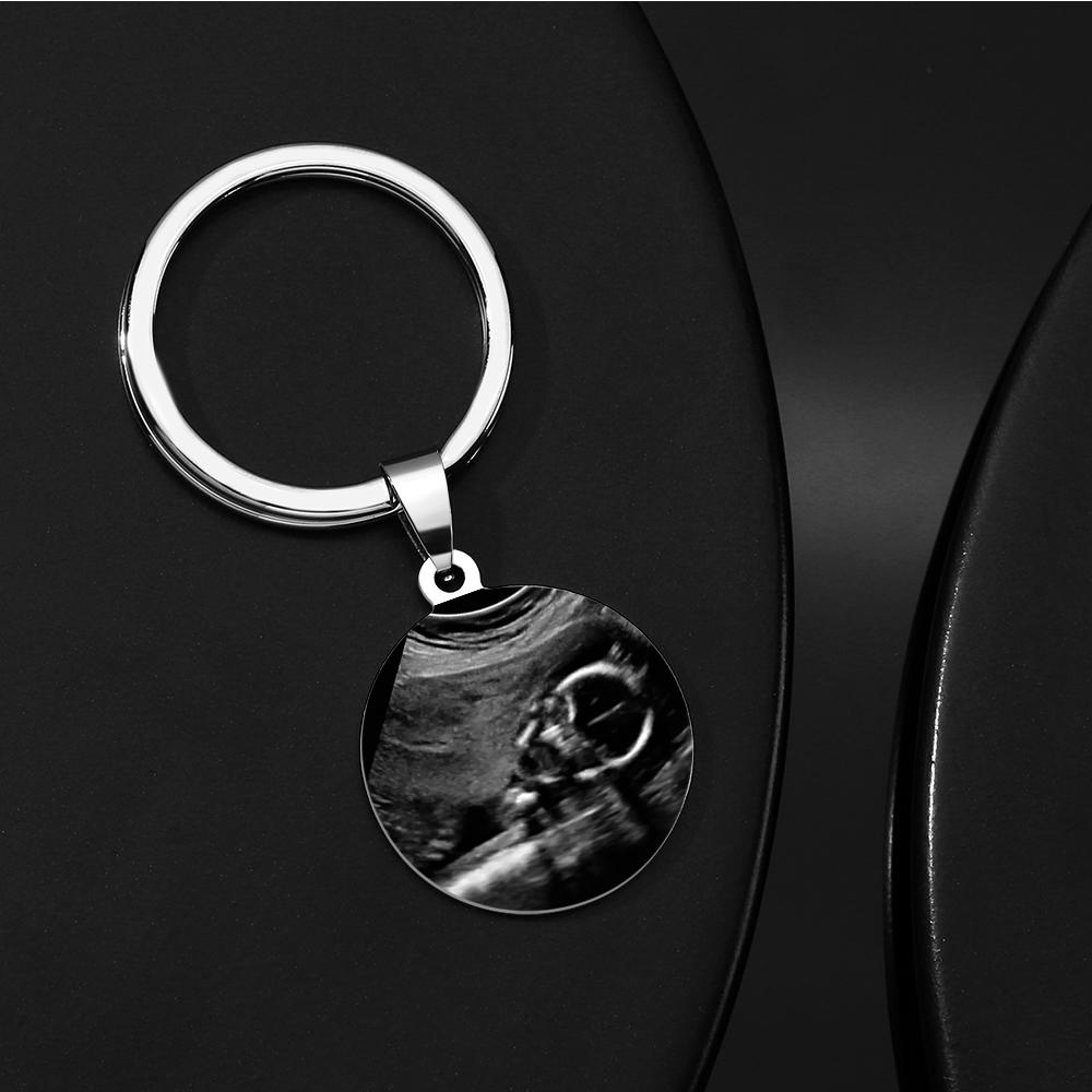 Close-up of engraved reverse of Daddy to Be keyring showing custom name and date — personalised stainless steel keepsake
