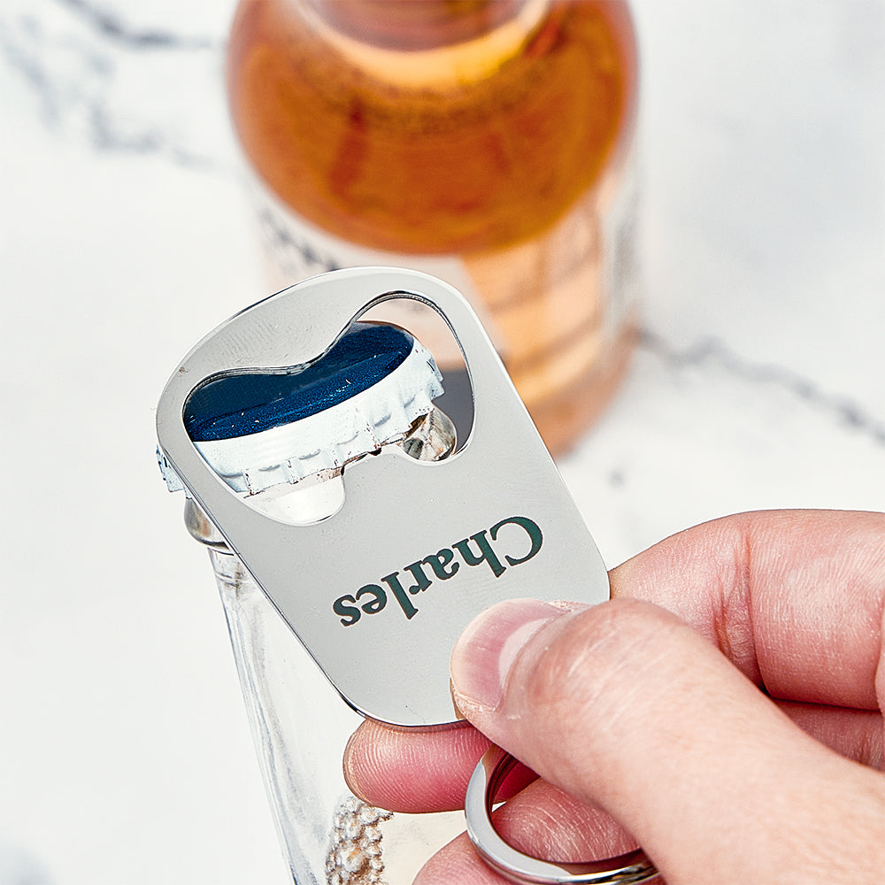 Close-up of personalised engraving on metal calendar keyring bottle opener showing custom name, date and fine engraving detail
