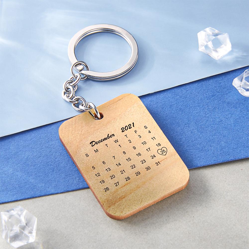 Close-up of personalised wooden key ring showing printed photo, engraved date and natural wood grain - custom photo keychain keepsake