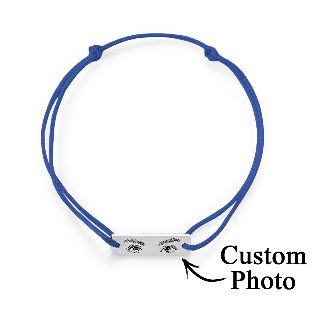Engraved charm against soft fabric, illustrating clarity of custom photo engraving on personalised eyes bracelet