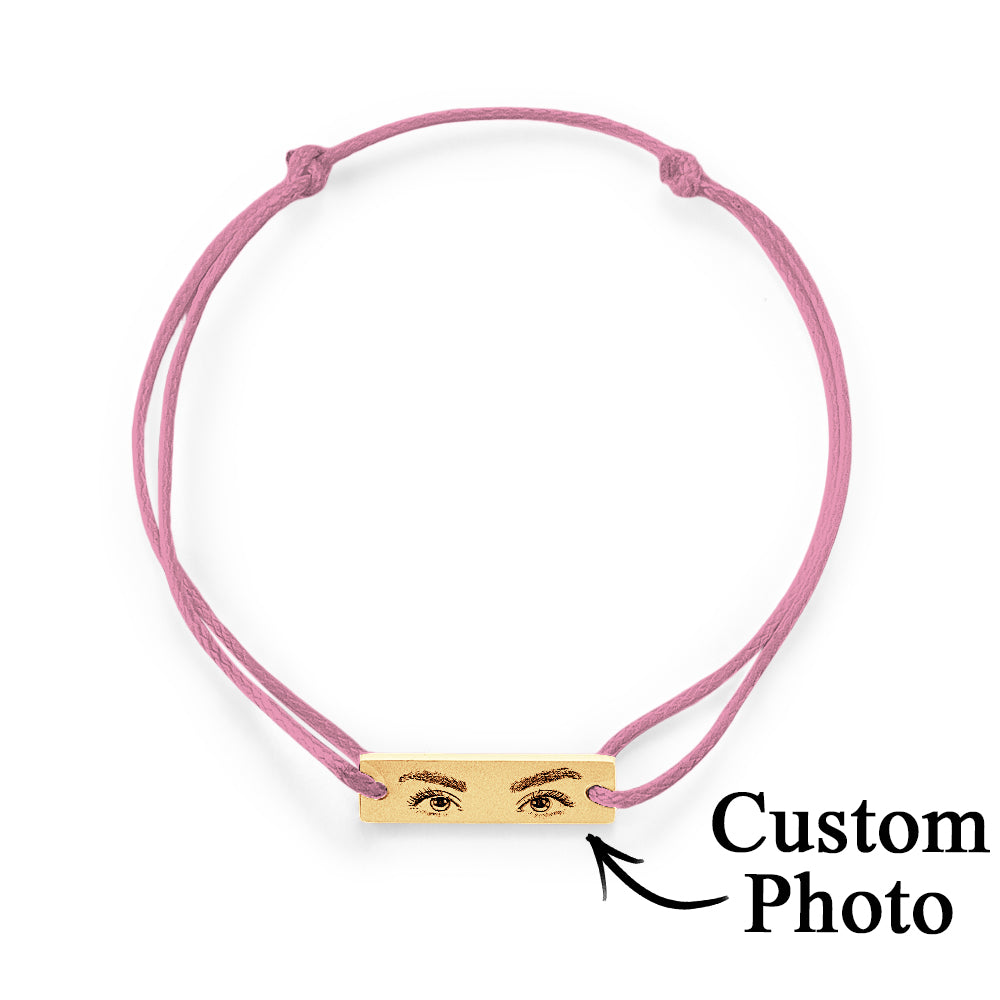 Personalised eyes charm photographed with natural light to show engraving contrast and lifelike detail