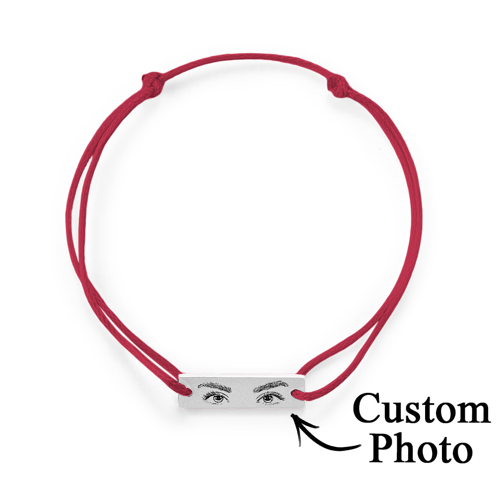 Hand model wearing personalised eyes photo bracelet — discreet stainless steel charm close to the skin