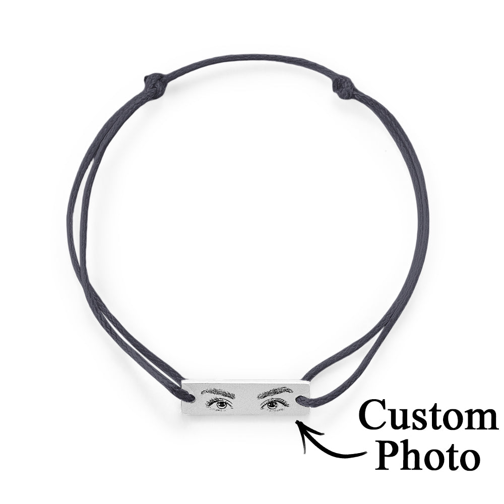 Detail image of the bracelet's hypoallergenic steel finish and the crisp engraving on the personalised eyes charm
