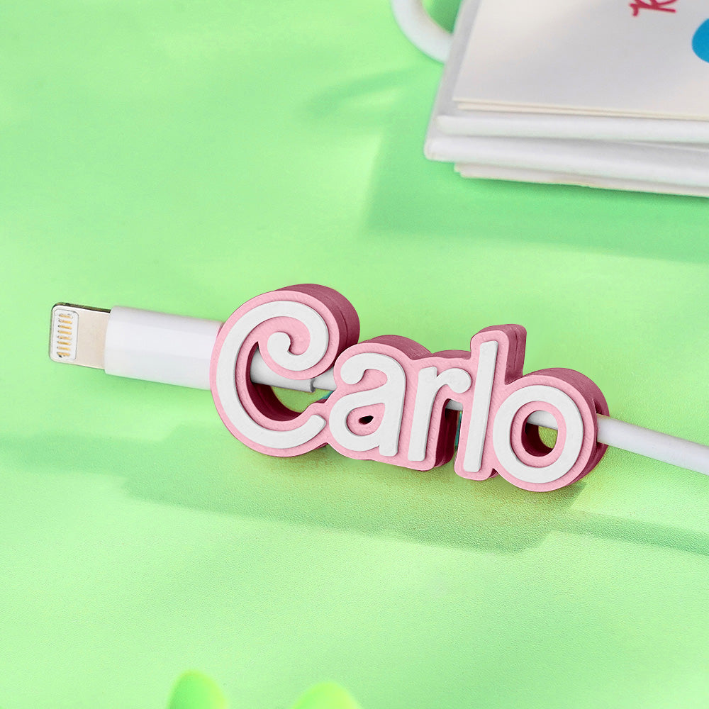 Compact cable organiser clipped around data and charging cables on a desk.