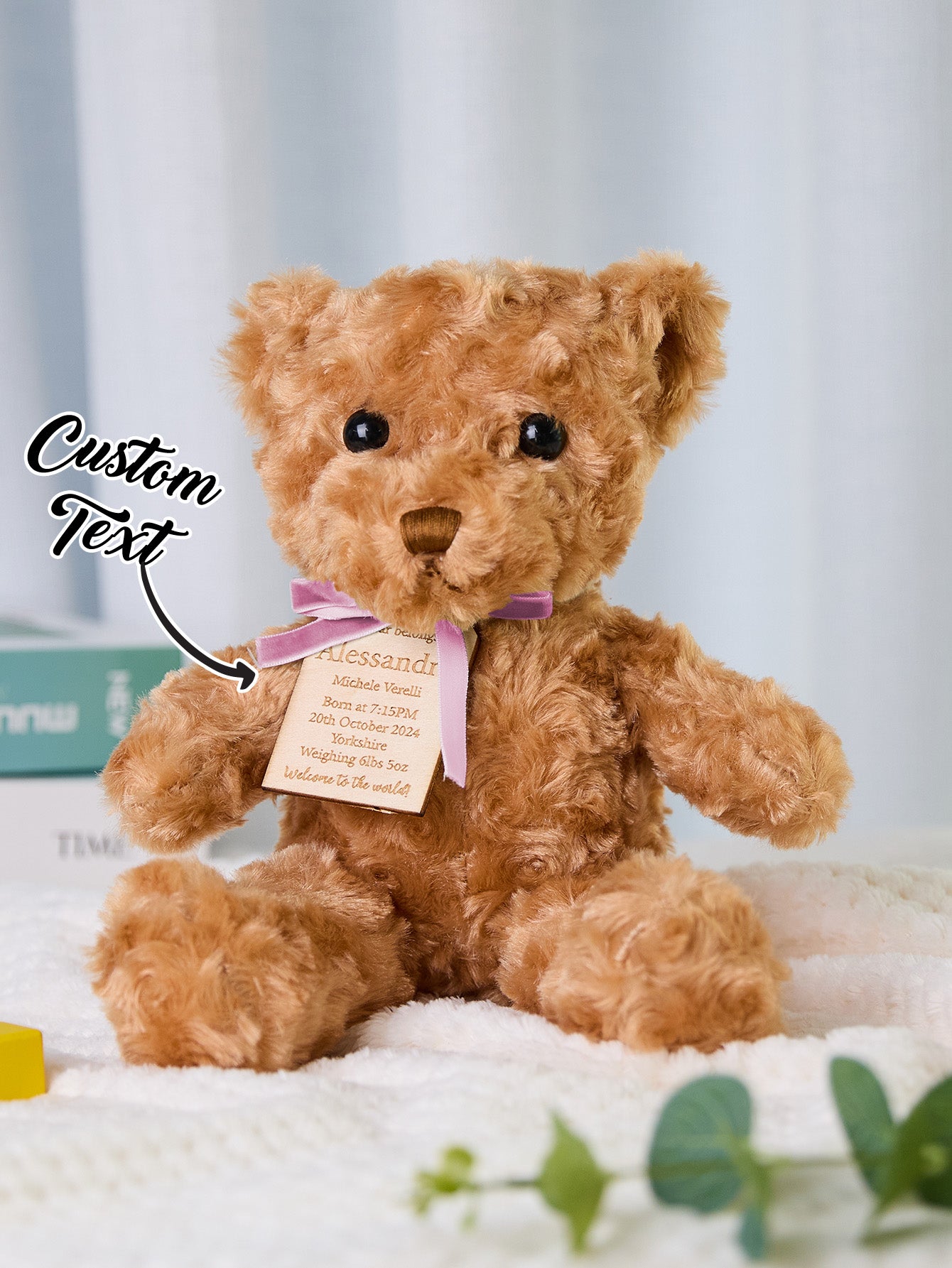 Detail shot of embroidered paw and name on personalised birth announcement bear, premium plush quality