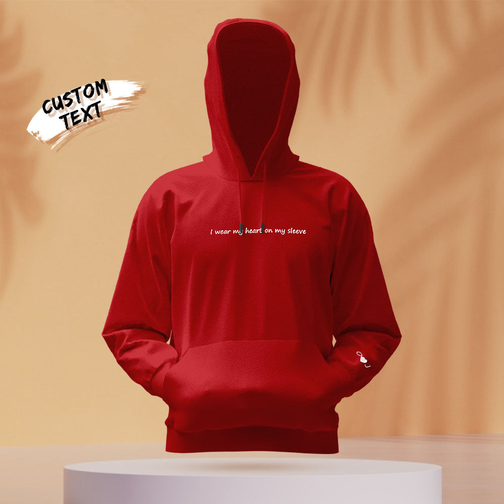 Flat-lay of personalised embroidered unisex hoodie showcasing fabric texture and neat personalised lettering