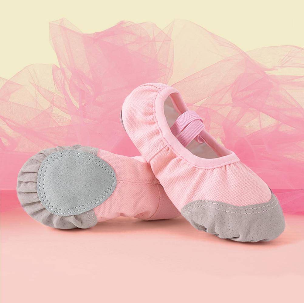 Red canvas split sole ballet shoes modelled by a child showing snug fit and natural foot movement perfect for beginners and young gymnasts