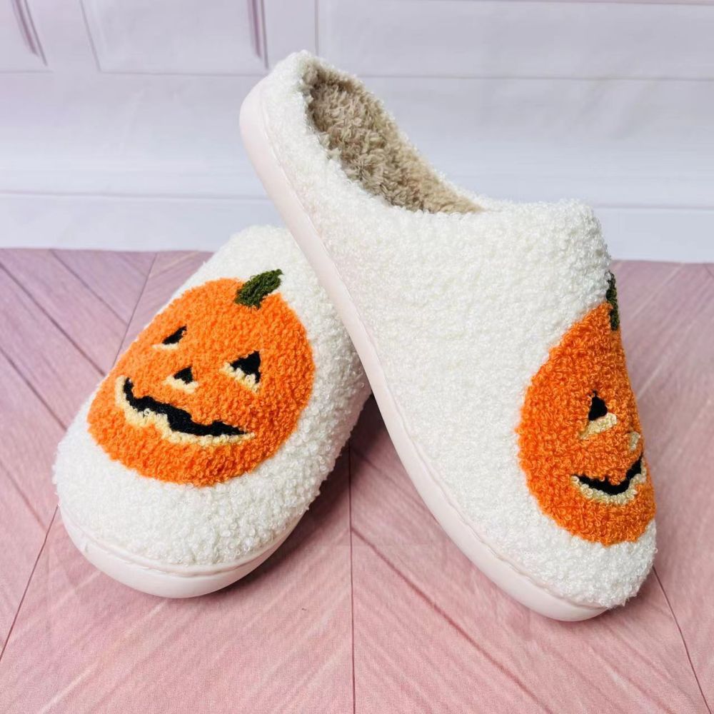 Side view of Halloween pumpkin slippers showing plush pumpkin motif and soft cotton-linen texture, unisex indoor shoes