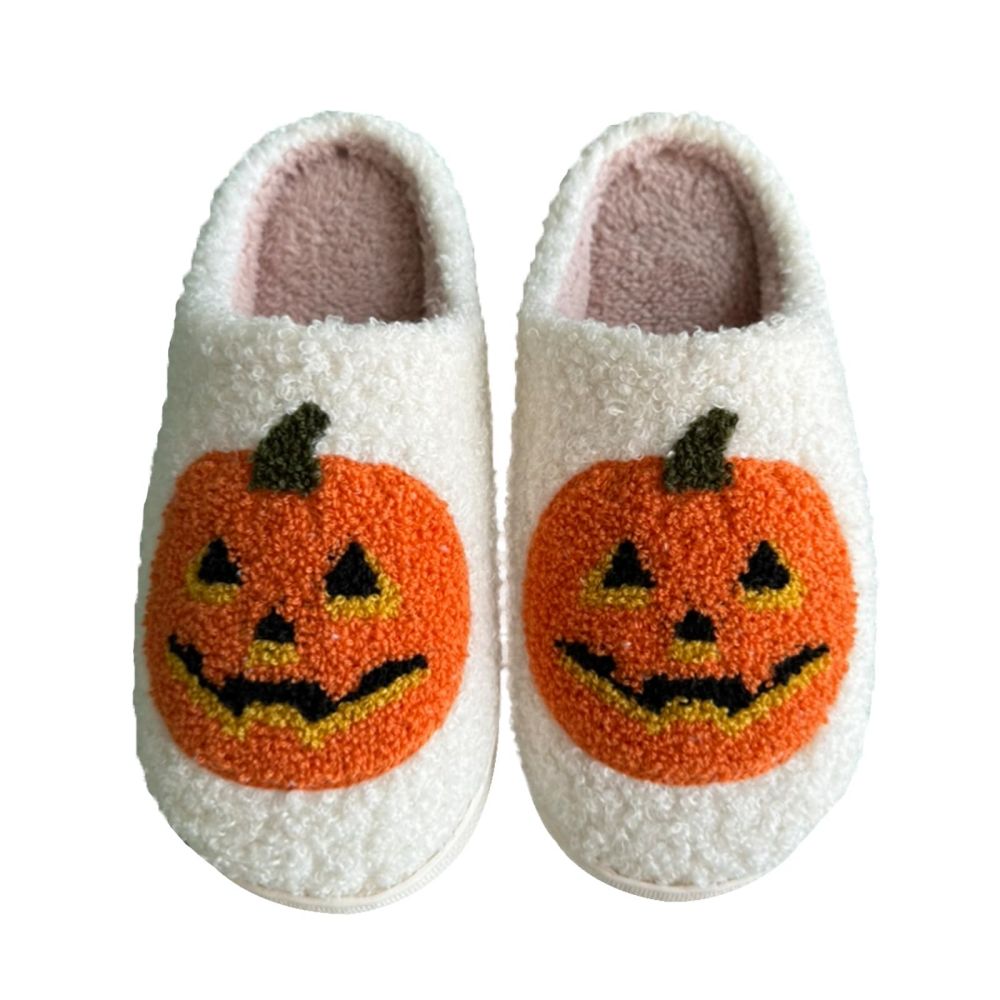 Close-up of pumpkin motif detail on plush slippers highlighting stitched features and soft polyester-cotton plush exterior