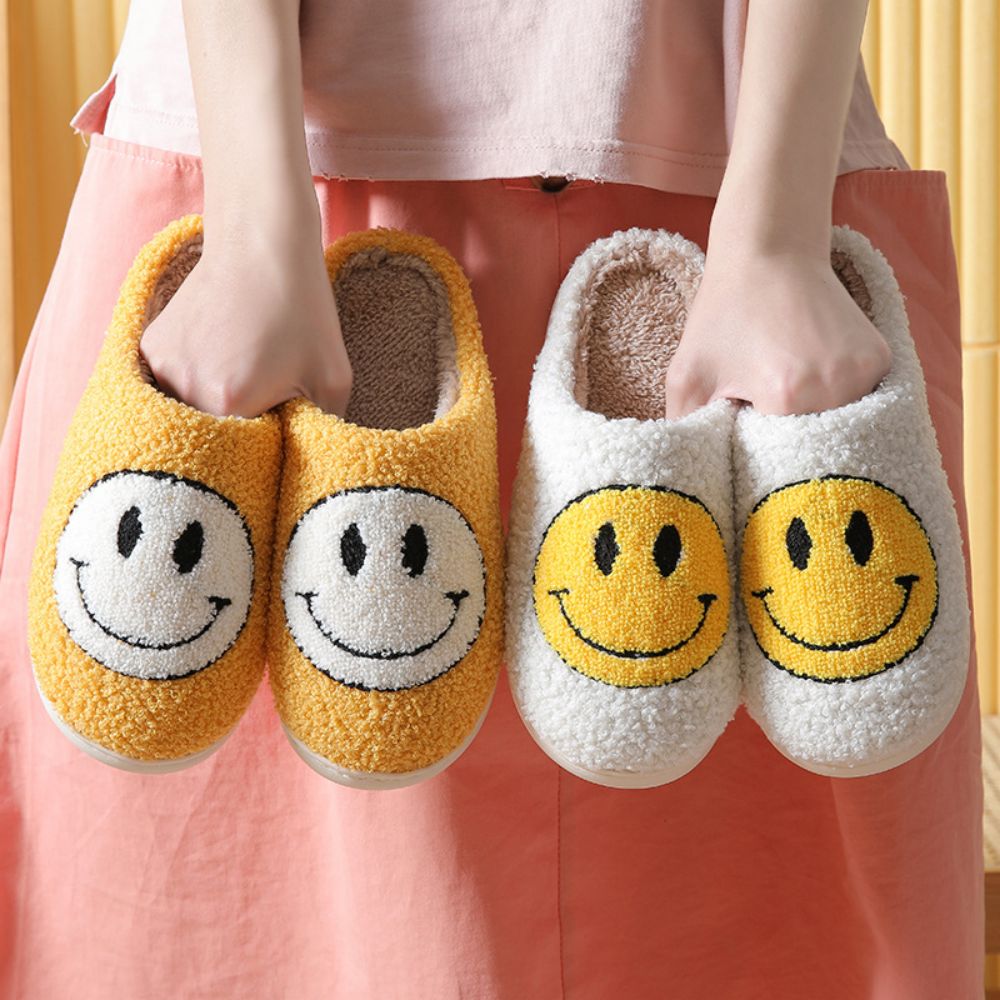 Top view of fluffy cosy smiley face slippers displaying soft interior lining and cheerful smile motif — ideal indoor slippers for women and men