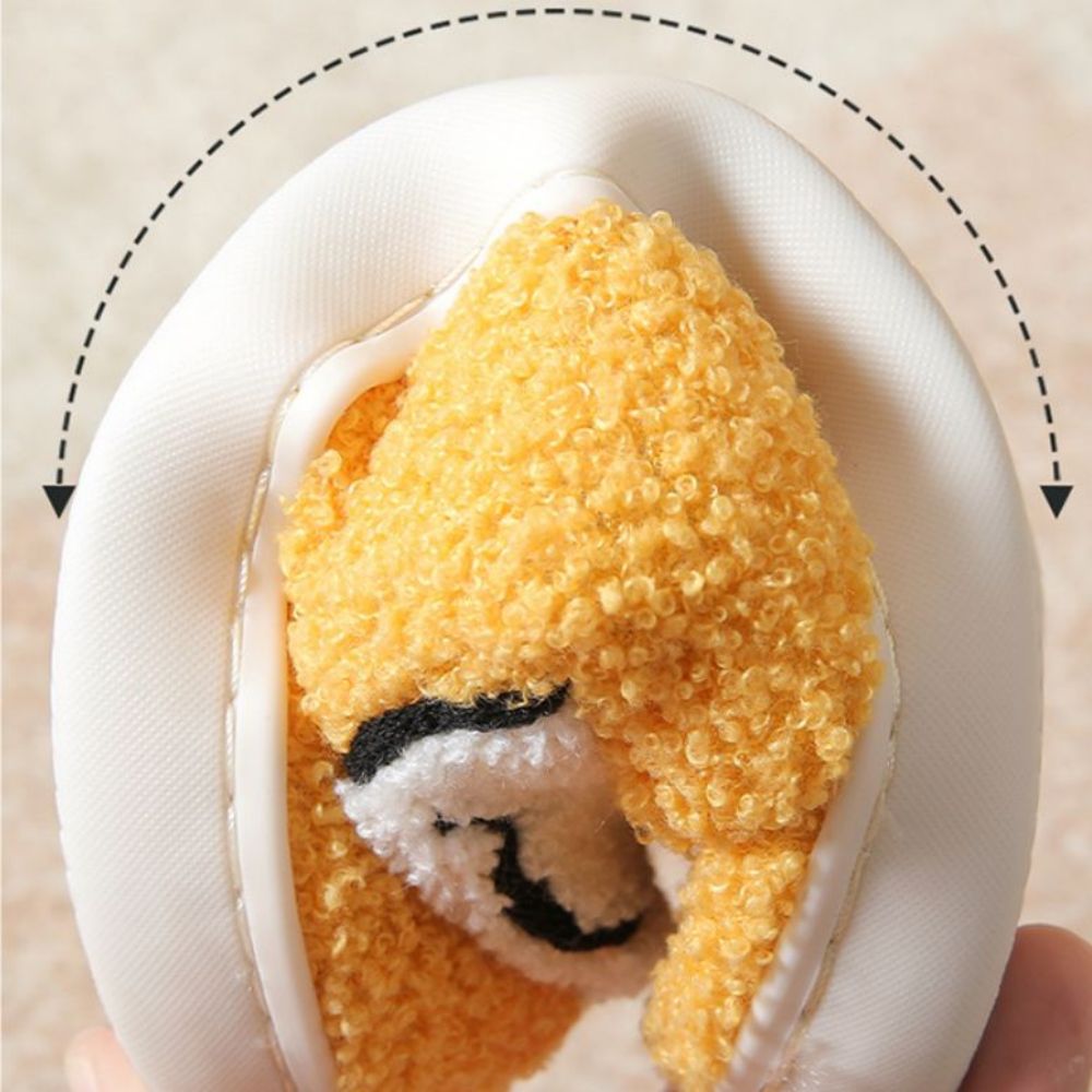 Close-up of smiley face motif and plush texture on cosy slippers, highlighting soft cotton–polyester lining and fluffy finish