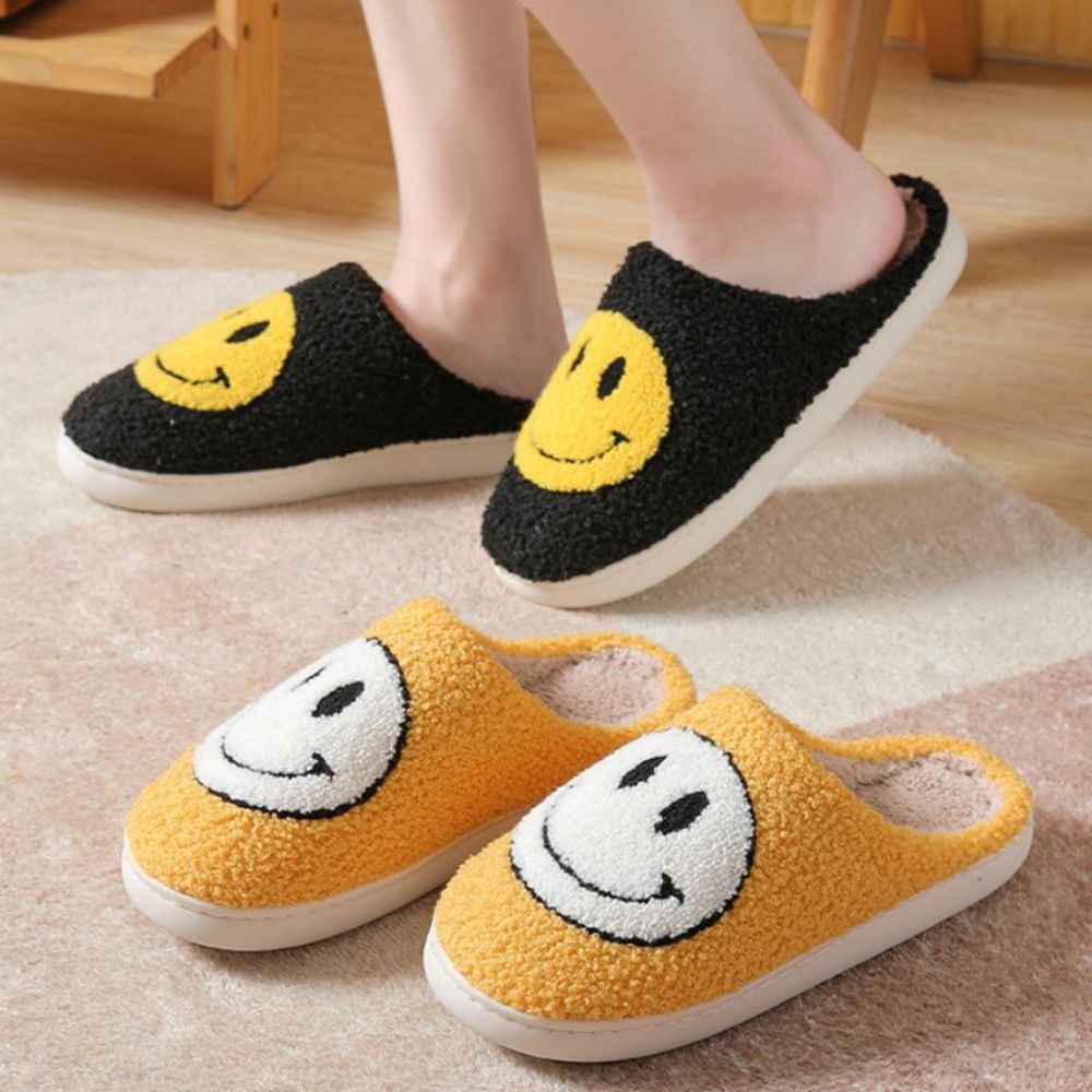 Unisex Smiley Face slippers worn on bathroom tiles to demonstrate non-slip PVC sole and safe indoor use