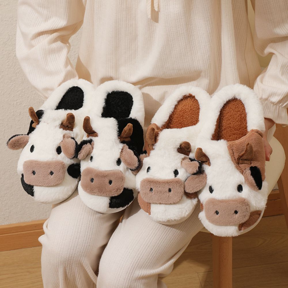 Side view of cow cartoon slippers showing plush lining and cushioned EVA footbed for warm indoor wear