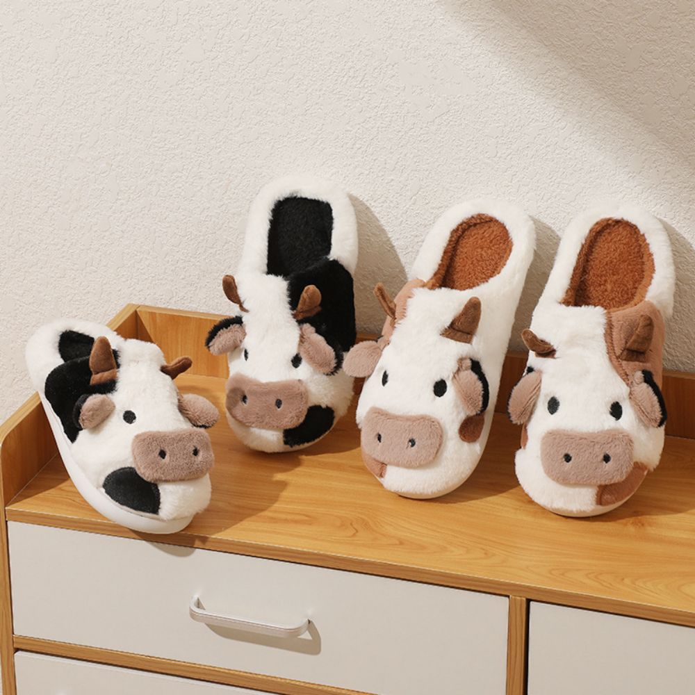Close-up of fluffy upper and soft texture on cow cartoon slippers, detail of plush lining and stitching