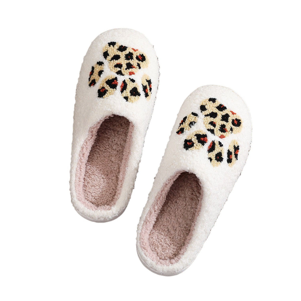 Close-up of leopard paw-print Christmas motif on plush cosy cotton upper highlighting decorative festive design