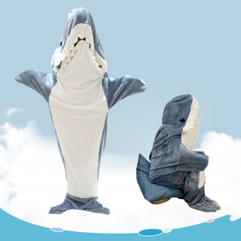 Adult model wearing wearable shark blanket hoodie on sofa — novelty shark loungewear for cosy nights and movie marathons