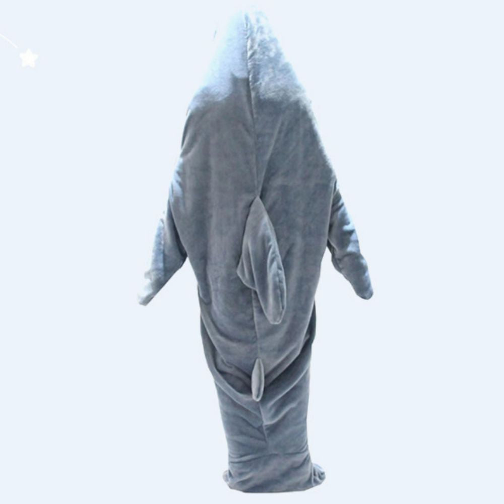 Person snuggled in flannel shark sleeping bag on bed — perfect novelty shark loungewear for sleepovers and camping