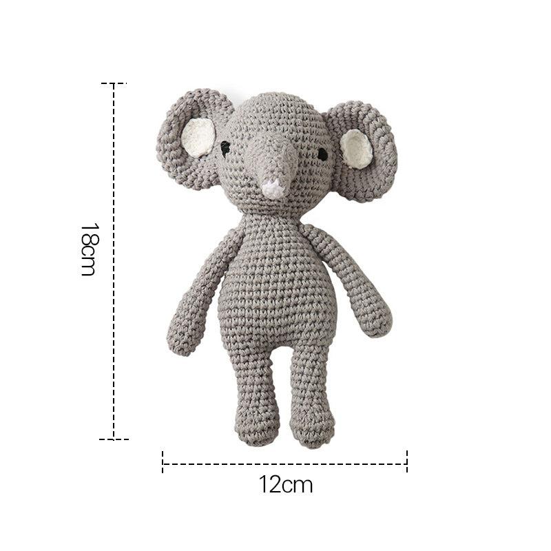 Close-up of crocheted cotton animal head on wooden ring rattle – handcrafted sensory toy and newborn comforter