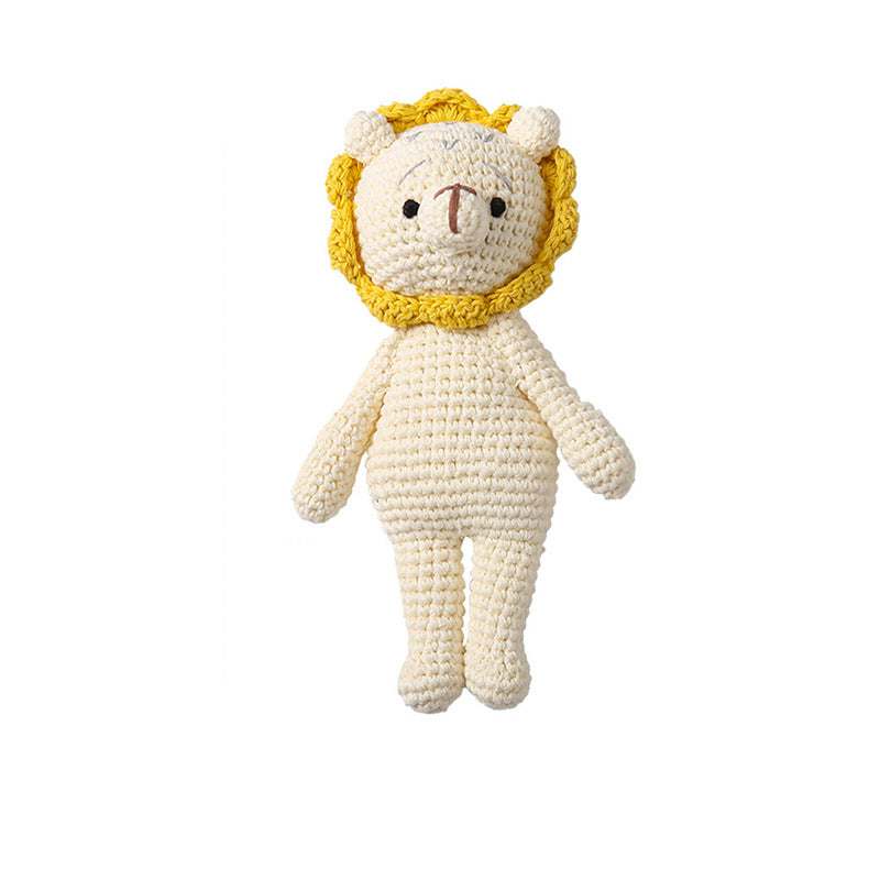 Knitted animal rattle arranged on a wooden surface to emphasise natural materials and eco-friendly design