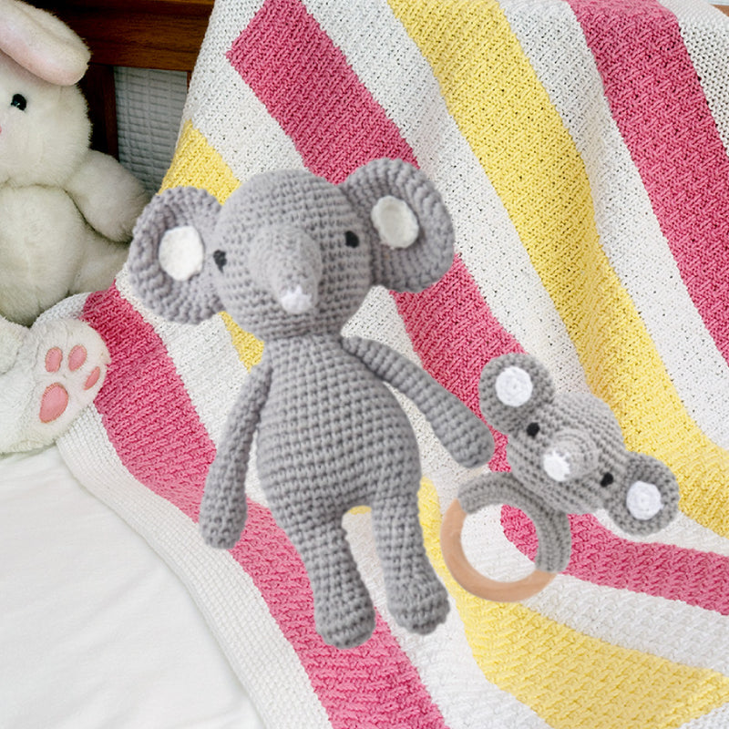 Macro of stitched facial features on crocheted animal head – safe tactile detail on a sensory baby rattle