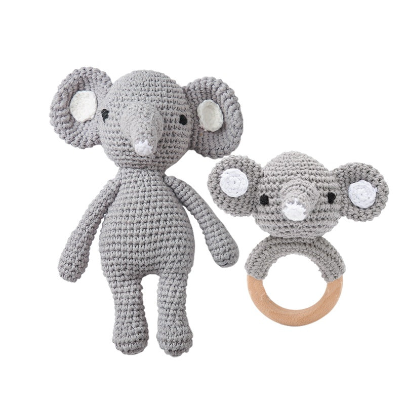 Textural macro showing crochet stitch detail and wooden ring join on a handmade baby rattle